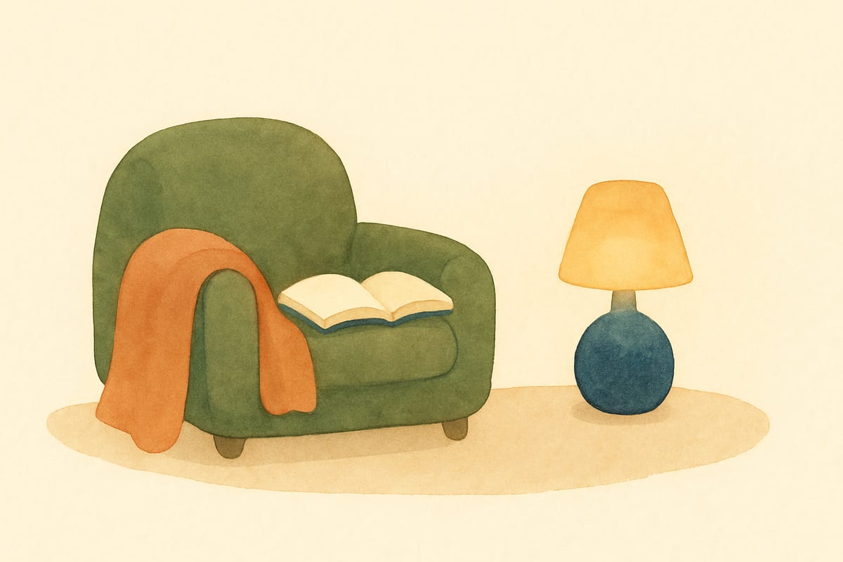 Soft watercolor illustration of a cozy reading nook with a rounded armchair, a blanket, and a warm lamp